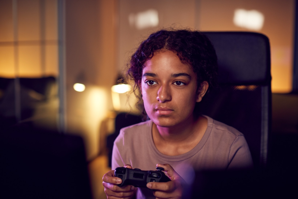 Teenage girl with game pad sitting in chair and ga 2024 10 19 02 18 25 utc