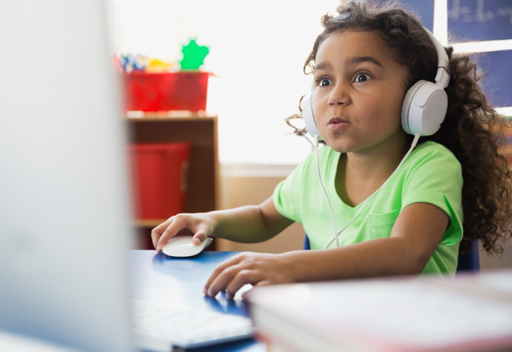 Young child learning using computer with headphone 2026 03 26 05 10 57 utc