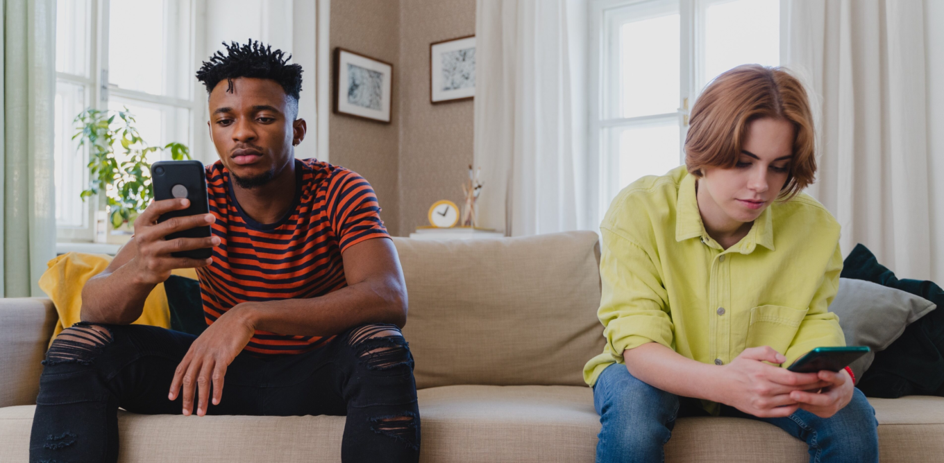 Two young adults sitting on sofa using phones 2026 03 25 10 48 45 utc