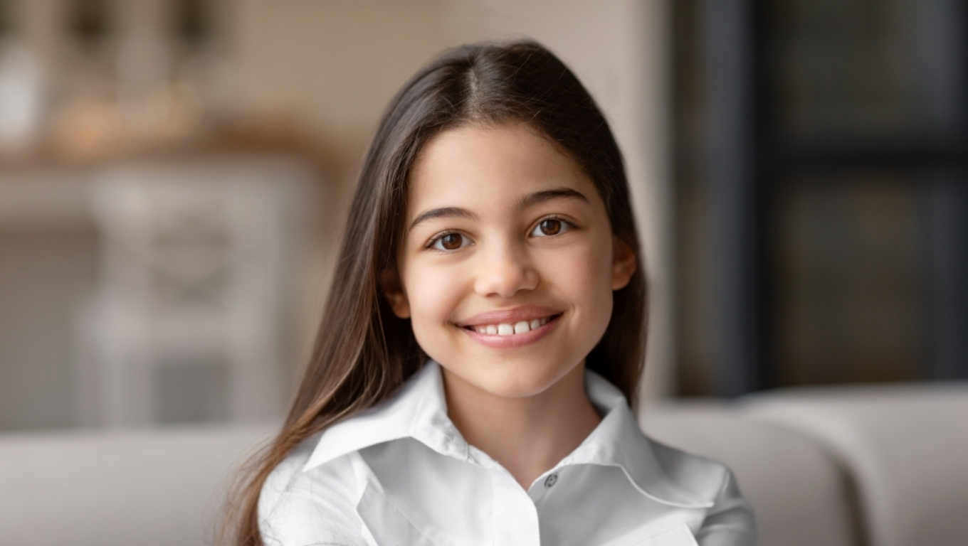 Preteen girl smiling at camera