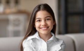 Girl smiling at camera (HERO, Advocacy Priorities)